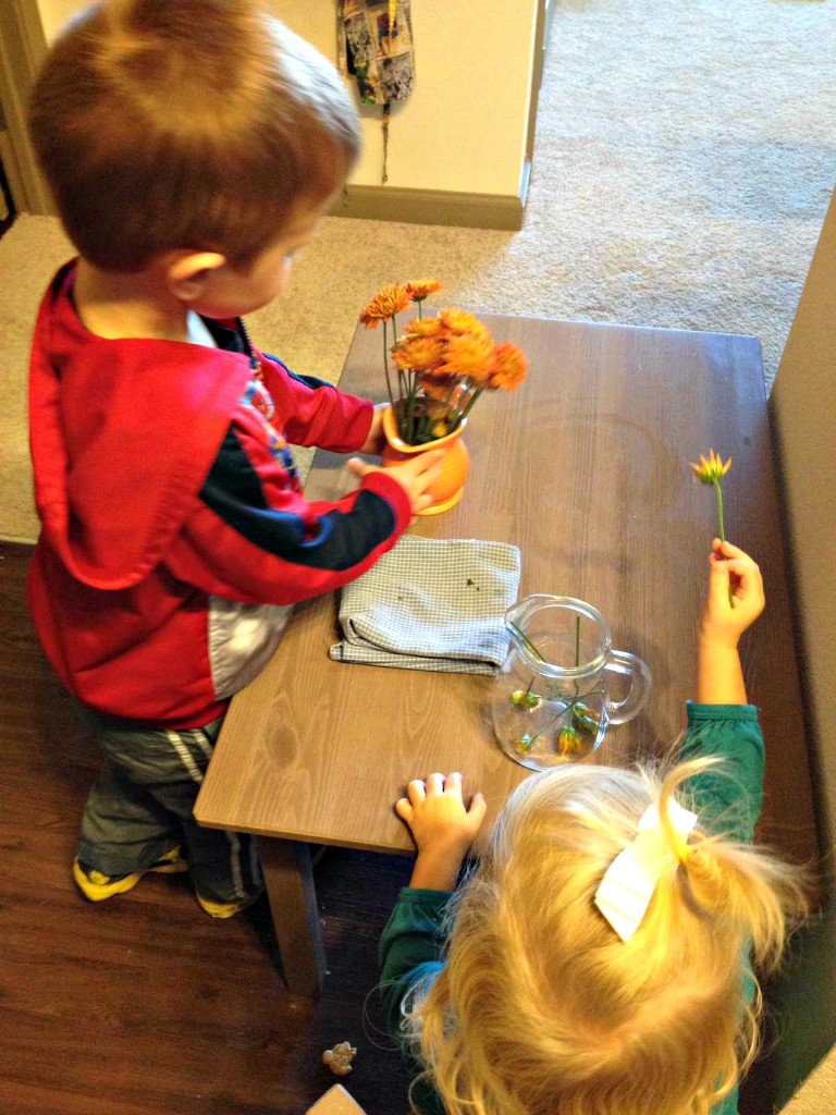 Flower arranging is a fun practical life activity to help kids stay involved in preparing the home for Christmas on ChristianMontessoriNetwork.com 